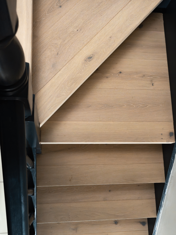 Light hardwood stairs in hallway