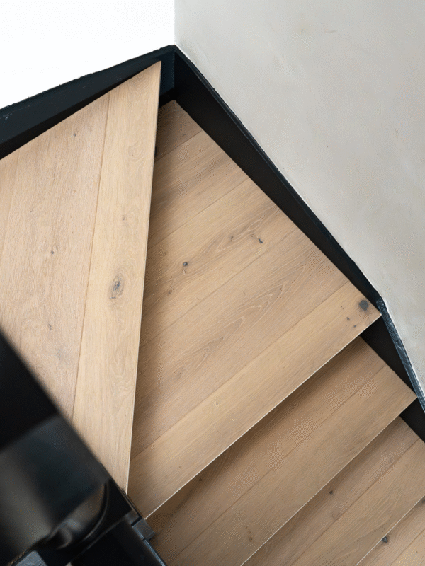 Light hardwood stairs in hallway